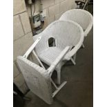 A pair of white painted loom chairs with table.