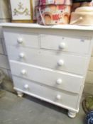 A painted 2 over 3 chest of drawers.