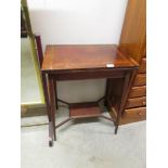 An Edwardian mahogany inlaid fold over card table.