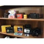 A quantity of vintage cameras and other photographic equipment (2 shelves).