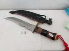 An ornamental knife in sheath.