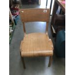 A vintage wooden school chair.