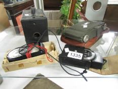 A Ross Ensign folding camera in case, a Kodak box camera,