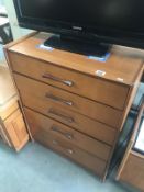 A teak 5 drawer chest of drawers.
