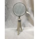 A magnifying glass on plastic stand.