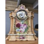 A floral decorated pottery mantel clock.