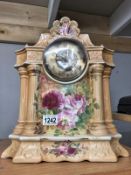 A floral decorated pottery mantel clock.