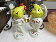 A pair of cast iron Esso figures.