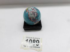 A small tin plate pocket globe.