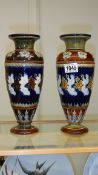 A pair of Royal Doulton salt glaze floral vases.