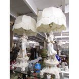 A pair of impressive gilded figural table lamps with shades.