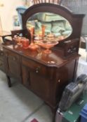 A 2 drawer 2 door dark wood side cabinet with curved legs,
