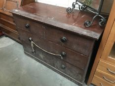 A 2 over 2 dark wood chest of drawers.