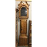 An arched top pine Grandfather clock case.