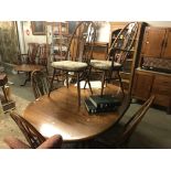 An Ercol dining table and 6 Ercol dining chairs.