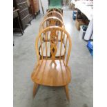 A set of 4 light Ercol 'Fleur-de-lys' dining chairs.