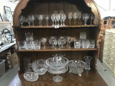 A large quantity of glassware including bowls, vases, cake stand etc.