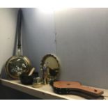 A copper and brass warming pan along with other brass items including shell case.