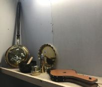 A copper and brass warming pan along with other brass items including shell case.