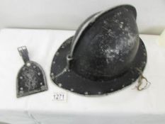 A vintage aluminium fireman's? helmet with badge.