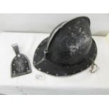 A vintage aluminium fireman's? helmet with badge.