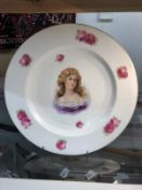 A large Czechoslovakian plate hand painted with a portrait of a lady.