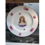 A large Czechoslovakian plate hand painted with a portrait of a lady.