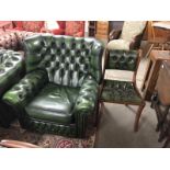 A green leather wing arm chair and matching dining chair,