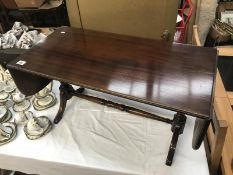 A wooden drop leaf coffee table.