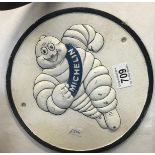 A round cast iron Michelin sign.