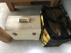 A case and bag of assorted LP records.