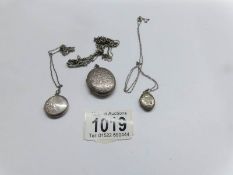 3 silver lockets on silver chains.