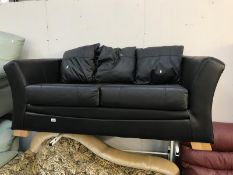 A black leather 2/3 seater sofa.