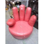 A pink chair in the form of a hand, a/f.