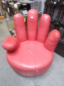 A pink chair in the form of a hand, a/f.