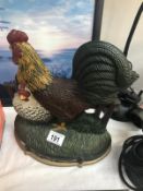 A cast iron cockerel door stop.