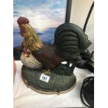 A cast iron cockerel door stop.