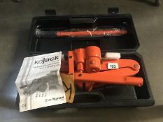 A cased kojack hydraulic caravan scissor jack and levelling aid.