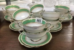 12 Paragon soup bowls and saucers with green and gold decoration.