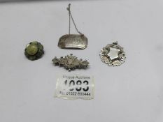 A silver brooch, a silver fob, a stone set silver brooch and a silver 'Madeira' wine label.