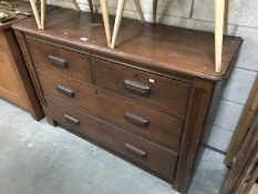 An Edwardian oak chest of 2 over 2 drawers.