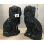 A pair of Victorian black Staffordshire dogs.