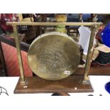 A brass dinner gong on stand.