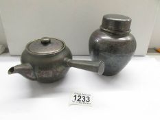 A 1920's Japanese pewter teapot and tea caddy with tea, (caddy is signed).