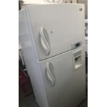An LG fridge-freezer with water dispenser.