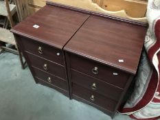 A pair of dark wood effect bedside drawers.