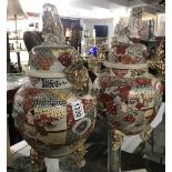 A large pair of 19th century lidded Satsuma vases, one restored.