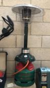 A table top patio heater with gas cylinder.