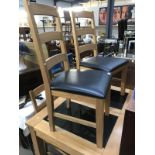 A marble slab inlaid kitchen table and 4 kitchen chairs.