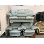 A green leather 3 piece suite with foot stool.